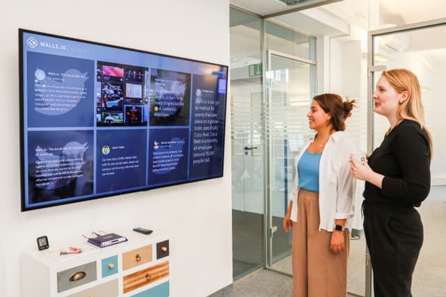 A woman recording a podcast with a microphone and headphones